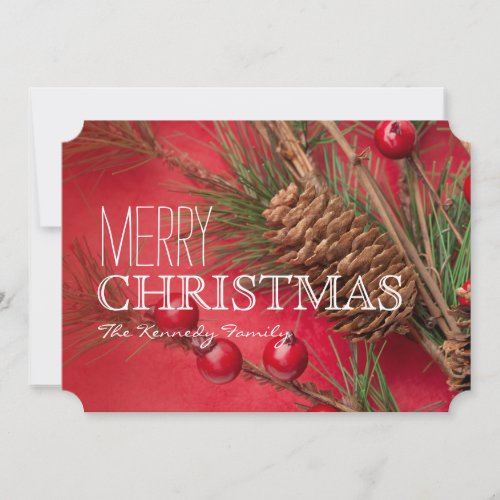 Pine cones and berries decoration on red paper holiday card