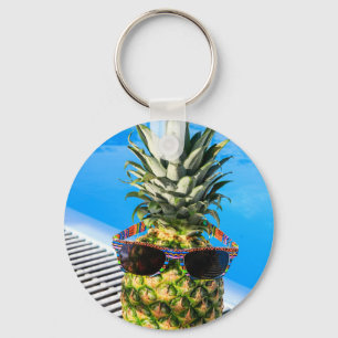 Pineapple wearing sunglasses at swimming pool keychain