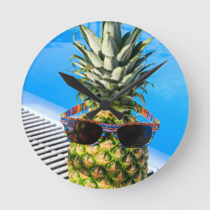 Pineapple wearing sunglasses at swimming pool round clock