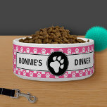 Pink And Black Dog Paws With Custom Text Bowl<br><div class="desc">This pet bowl has a white dog paw inside a black circle in the middle. Around it there are two customizable text areas that now read "dinner" and pet's name. The background has a pattern of white dog paw prints on a pink color. The pink color can be changed to...</div>