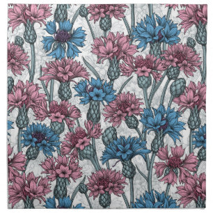 Pink and blue cornflowers, wild flowers on white cloth napkin