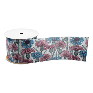Pink and blue cornflowers, wild flowers on white satin ribbon