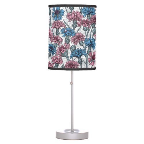 Pink and blue cornflowers wild flowers on white table lamp