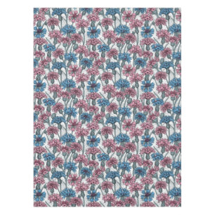 Pink and blue cornflowers, wild flowers on white tablecloth