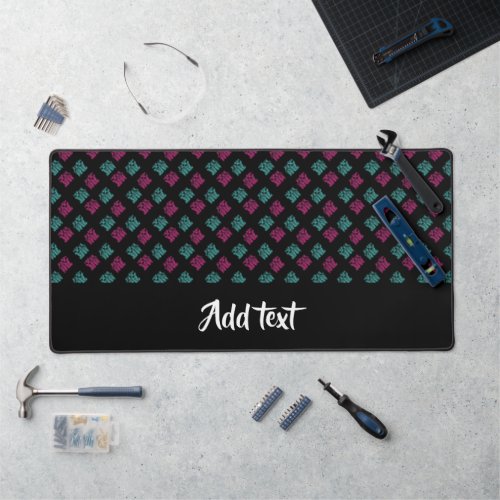 Pink and blue decorative print on  black desk mat