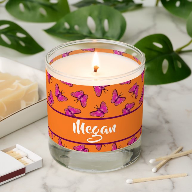 Pink and purple butterflies on orange scented candle (Lit)