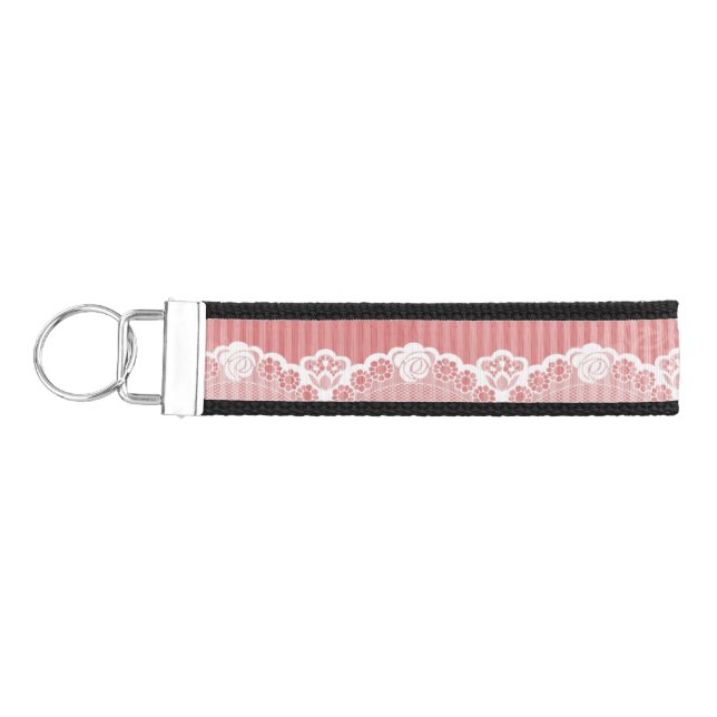 Pink and white background with black lace wrist keychain (Keys on Left)