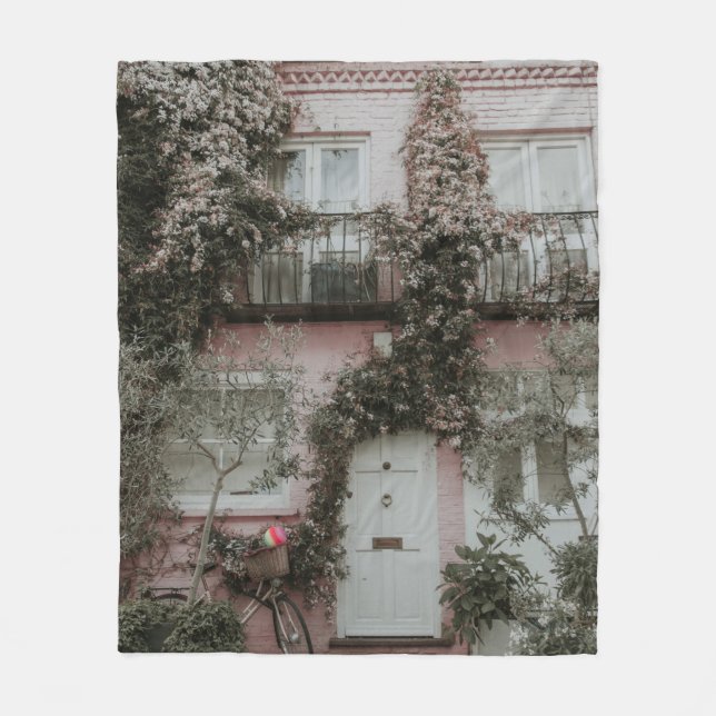 PINK AND WHITE PAINTED HOUSE COVERED WITH PLANTS A FLEECE BLANKET (Front)