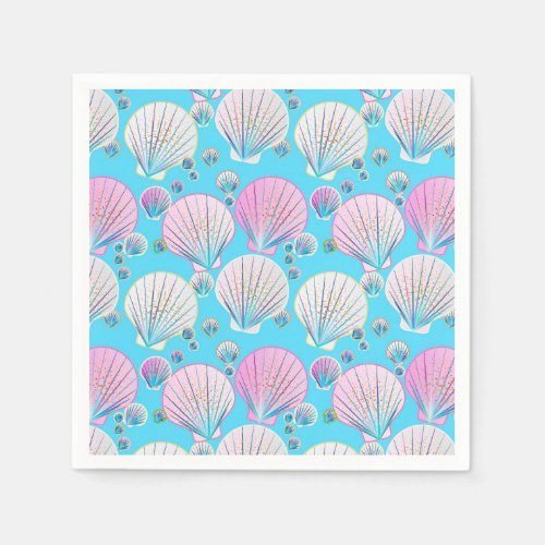 Pink and white sea shells on turquoise napkins