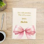 Pink bow beige cream quote 2026 planner<br><div class="desc">A soft beige, cream colored background, decorated with a large pink bow. Quote: Live with intention. Plan with purpose.</div>
