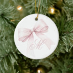 Pink Bow Christmas Ornament<br><div class="desc">Add a touch of elegance and femininity to your holiday decor with this beautiful Christmas ornament featuring a delicate pink bow and a personalized script initial monogram. The soft, girly design is perfect for bringing a cute and trendy accent to your Christmas tree. Easily customize with your initial for a...</div>