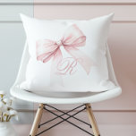 Pink Bow Throw Pillow<br><div class="desc">Add a touch of elegance and femininity to your space with this beautiful throw pillow featuring a delicate pink bow and a personalized script initial monogram. The soft, girly design is perfect for a stylish bedroom or living room, bringing a cute and trendy accent to any decor. Easily customize with...</div>