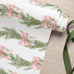 Pink Bow Winter Green Wrapping Paper<br><div class="desc">This wrapping paper features a soft, elegant design with light pink bows and green pine branches arranged in a repeating pattern. The delicate watercolor-style illustration gives it a serene and festive feel, ideal for a winter or Christmas theme. The white background enhances the airy and clean aesthetic, making it perfect...</div>