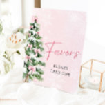 Pink Bows Christmas Tree Winter Baby Shower Favors Pedestal Sign<br><div class="desc">Add a touch of sweetness to your baby shower with this Pink Bows Christmas Tree Favors Sign! 🎀🎄 Featuring an adorable pink bow and a festive Christmas tree, this charming sign is perfect for leading your guests to their special treats. 💕 The soft pink hues and whimsical winter design create...</div>