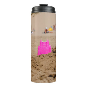 Pink castle toy in shore at daytime thermal tumbler