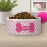 Pink Dog Bone And Paws With Name Bowl<br><div class="desc">Pink dog bone silhouette with a personalizable text area for pet's name or other custom text such as "food" or "water", for example. The background color is light pink with a pattern of white dog paw prints. Make your pet's dining area chic while adding a pop of pink color to...</div>