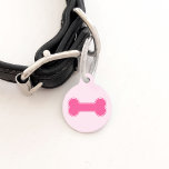 Pink Dog Bone And Pet's Information Pet Tag<br><div class="desc">This pet tag features a pink dog bone shape on the front and on the other side there are personalizable text areas for the name of the pet and for a phone number. The background color is light pink.</div>