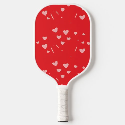 Pink floating hearts on red pickleball paddle