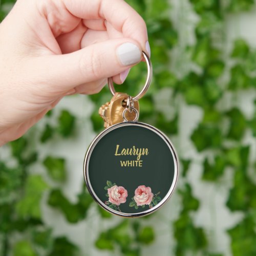 Pink flower and leaves on dark green keychain