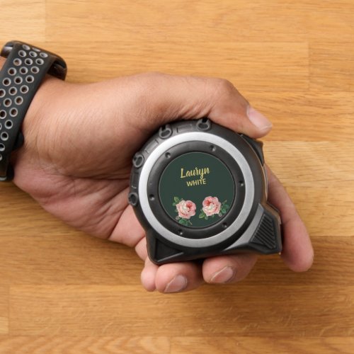 Pink flower and leaves on dark green tape measure