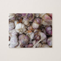 Pink garlic background with whole garlic bulbs