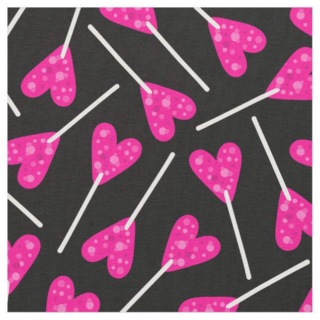 pink heart shape lollipop candy black fabric (Close Up)