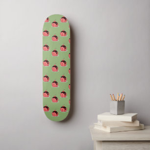 Pink ice cream cups on green skateboard