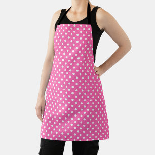 Pink polka dot apron with black straps, shown flat
