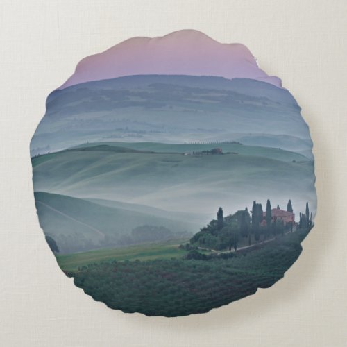 Pink sunrise over a Tuscany landscape round pillow