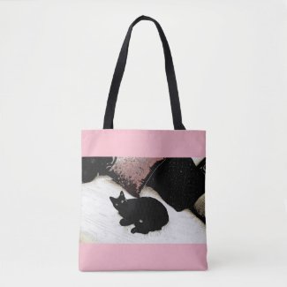 Pink tote with black cat on a bed of pillows