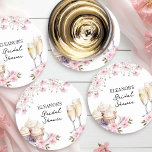 Pink Wildflowers Champagne Glasses and Cupcakes Round Paper Coaster<br><div class="desc">Champagne bridal shower stickers. This delicate design features champagne glasses, cupcakes and pink flowers with sweet handwritten typography. Perfect for pink bridal showers, petals or pearls and processco themes, brunch and bubbly, afternoon tea etc. Please browse my Cupcakes and Cava Bridal Shower Collection for co-ordinating games and signs or message...</div>