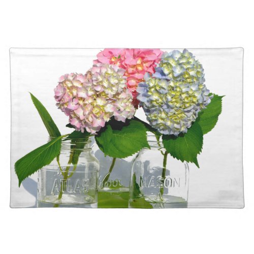 Pink yellow blue hydrangeas in mason jar cloth placemat