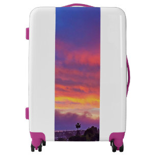 Pink yellow blue sunset clouds beautiful modern luggage