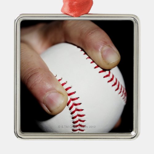 Pitchers hand gripping a baseball metal ornament