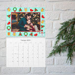 Pixel Retro Gamers Christmas Photo Calendar<br><div class="desc">Celebrate the year ahead with a calendar that fuses Christmas cheer and gaming nostalgia. Personalize the front with your family name, year, and a festive photo, framed by pixel art holiday motifs. Each month showcases your treasured family photos, complemented by a vivid blue background featuring pixelated presents, bells, and snowmen....</div>