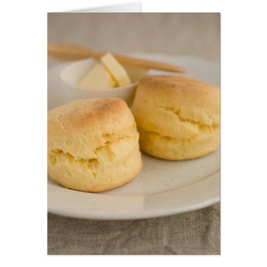 Plain scone with butter on plate (Front)