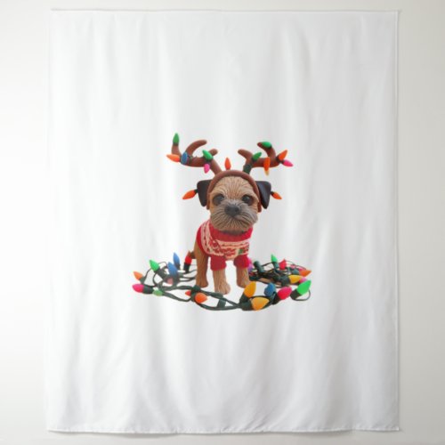 Playful Border Terrier helping with the Christmas  Tapestry