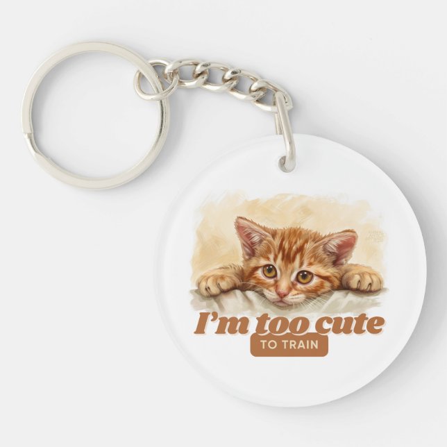Playful Cat “I'm Too Cute to Train” Keychain (Front)