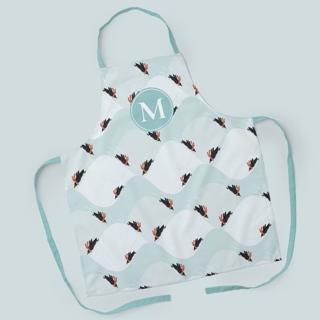 Playful Penguins Sliding on Snow Pattern Apron (Penguins sledding in the snow patterned apron with customizable monogram)