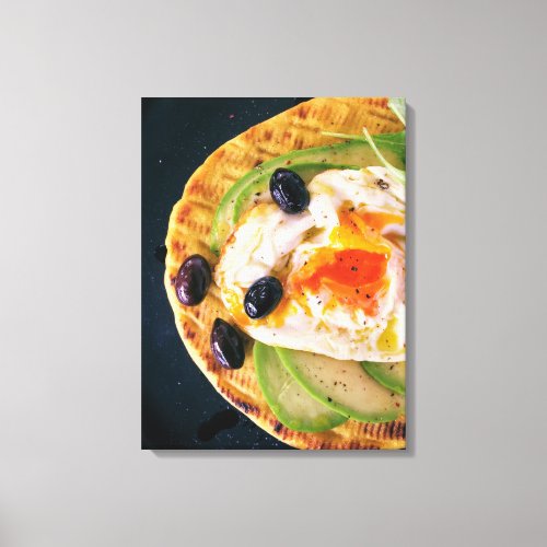 Poached egg on avocado and flat bread breakfast canvas print