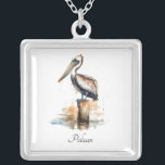 Poise of the Pelican Silver Plated Necklace<br><div class="desc">Carry the calm of the coast close to your heart with this silver-plated necklace featuring the Poise of the Pelican design. The delicate pendant showcases a serene watercolor scene of a pelican perched on a weathered dock post, evoking peaceful seaside moments and a love for nature. The design is set...</div>