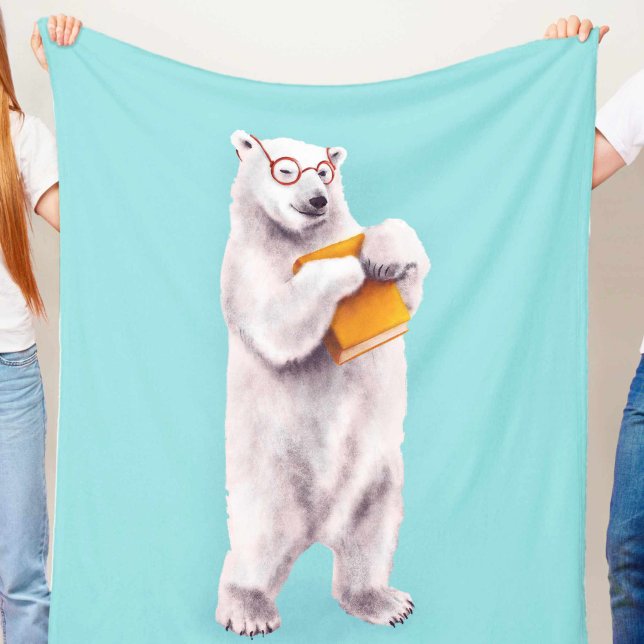 Polar Bear Book Lover Nerdy Fleece Blanket (blue blanket with a cute smiling polar bear with eyeglasses holding a yellow book, held in hands)