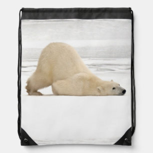 Polar bear scratching itself on frozen tundra drawstring bag