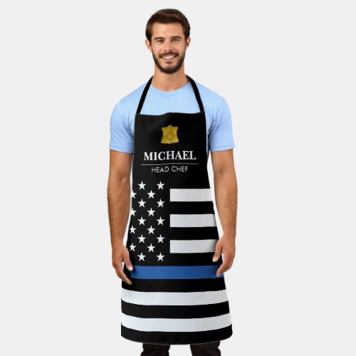 Police Thin Blue Line American Flag Apron - Law enforcement themed kitchen/BBQ apron for police officers. Featuring the american stars and stripes flag with the thin blue line, a gold officer badge, your name, and personalized title.