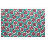 Pomegranate slices on turquoise fabric