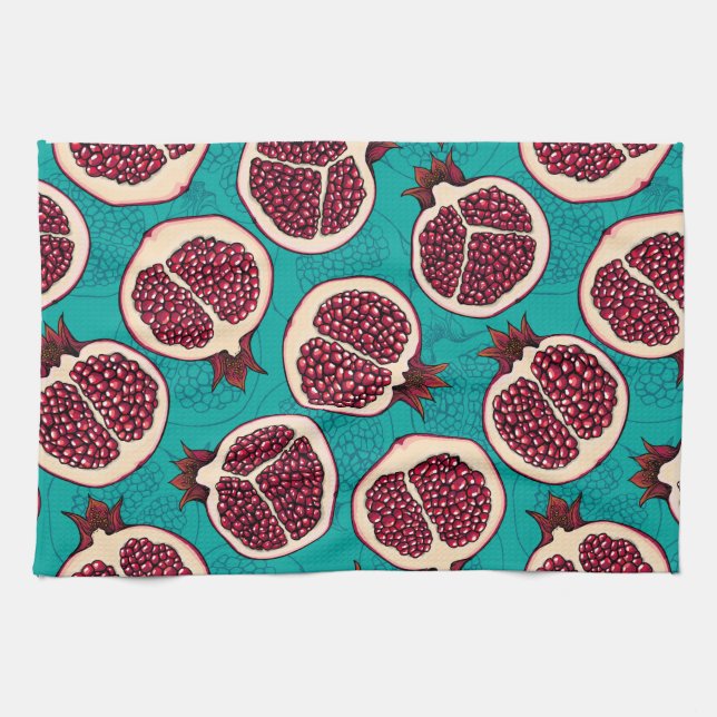Pomegranate slices on turquoise kitchen towel (Horizontal)