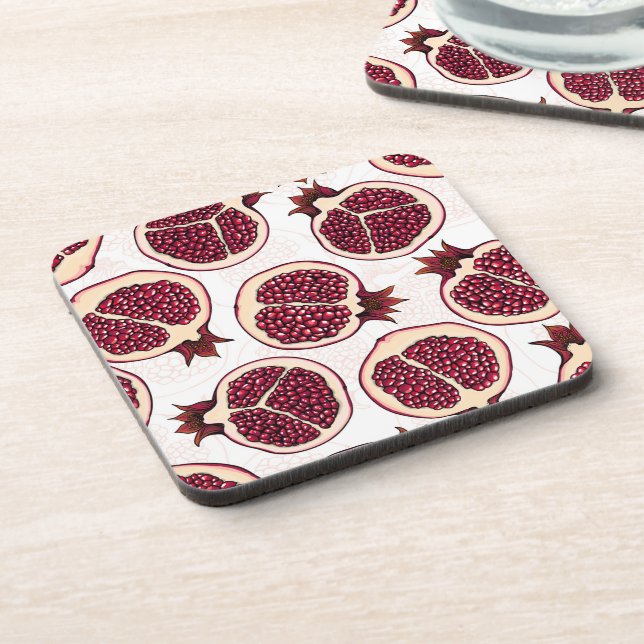 Pomegranate slices on white beverage coaster (Left Side)
