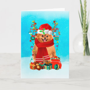 Pomeranian in snow with Christmas gifts Card