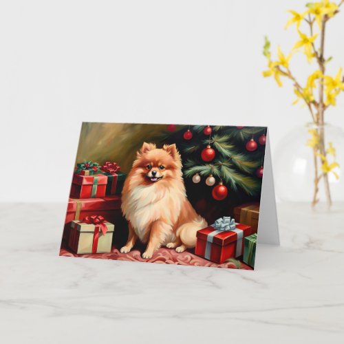 Pomeranian sitting by Christmas tree Card