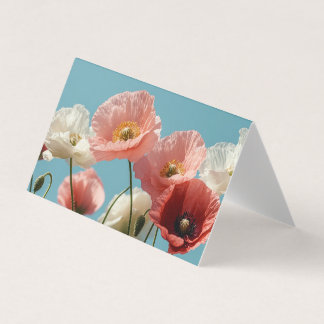 Poppies field against a blue soft sky	